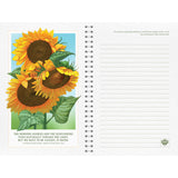 Notebook with sunflower illustration on the cover and lined pages.