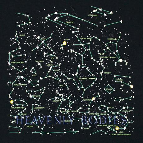 close up of the front of the tee design featuring constellations and "Heavenly Bodies' text