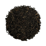 a round pile of lapsang souchong tea against a white background