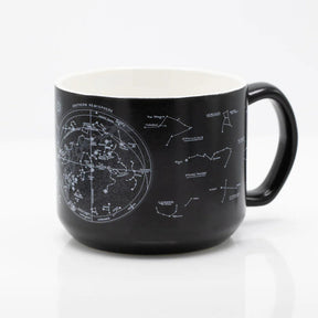 the other side of a black coffee mug with printed astronomy charts of the night sky and constellations