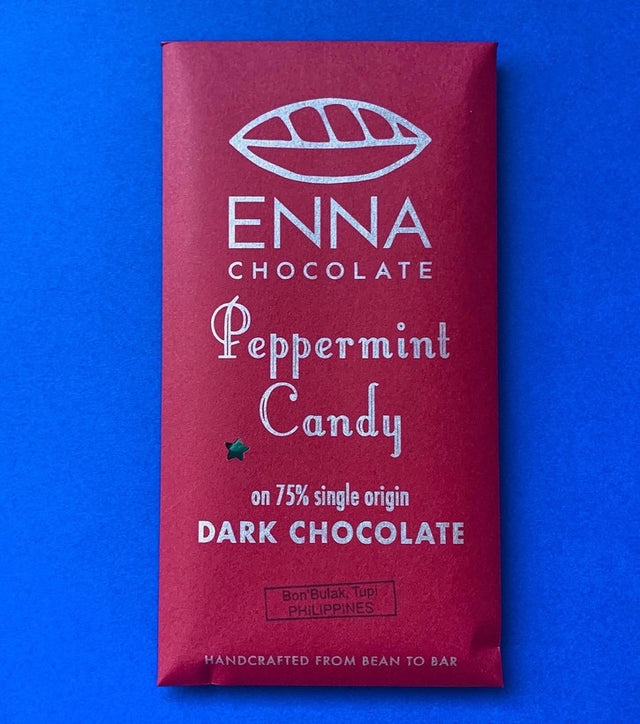 A festive burgundy red chocolate bar wrapper with the Enna Chocolate logo and "Peppermint Candy" in playful, festive text