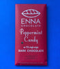 A festive burgundy red chocolate bar wrapper with the Enna Chocolate logo and "Peppermint Candy" in playful, festive text