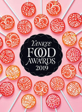 A black Yankee Food Awards logo encircled with colorful lollipops