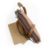 Brown leather crossbody bag with multiple zippers on a white background