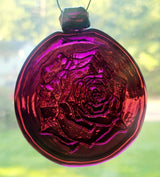 Purple glass suncatcher with a rose design.