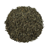 a heaping pile of loose green tea leaves